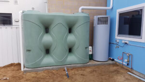 3000L Green Slimline Tank connected to a house