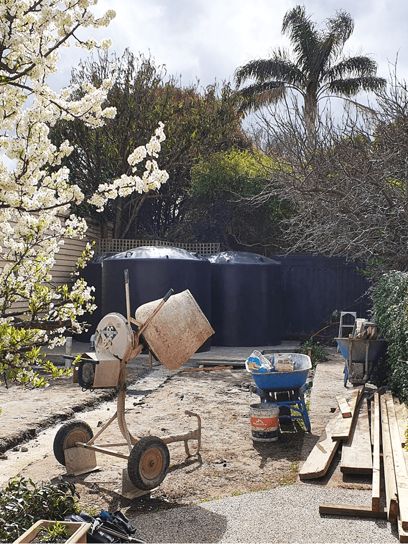 2 Polymaster large smooth water tanks sitting on a backyard
