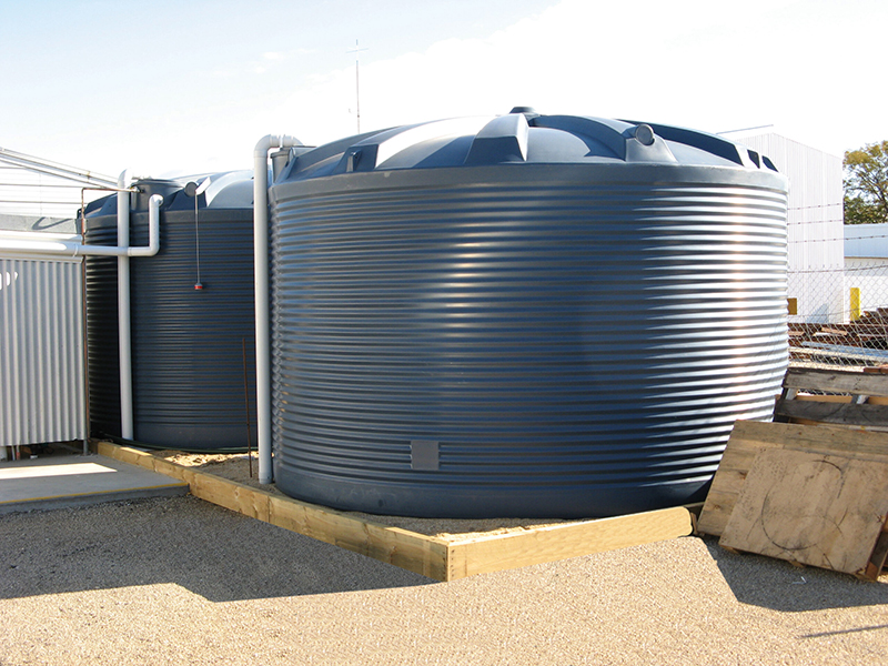 Two dark blue 31,700L Polymaster Water Tanks with visible pipework