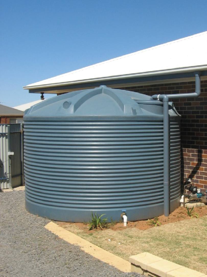 Grey Polymaster water tank installed beside a residential home