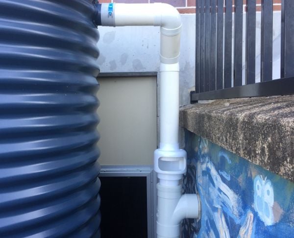 A tight shot of the gap between water tank and the wall