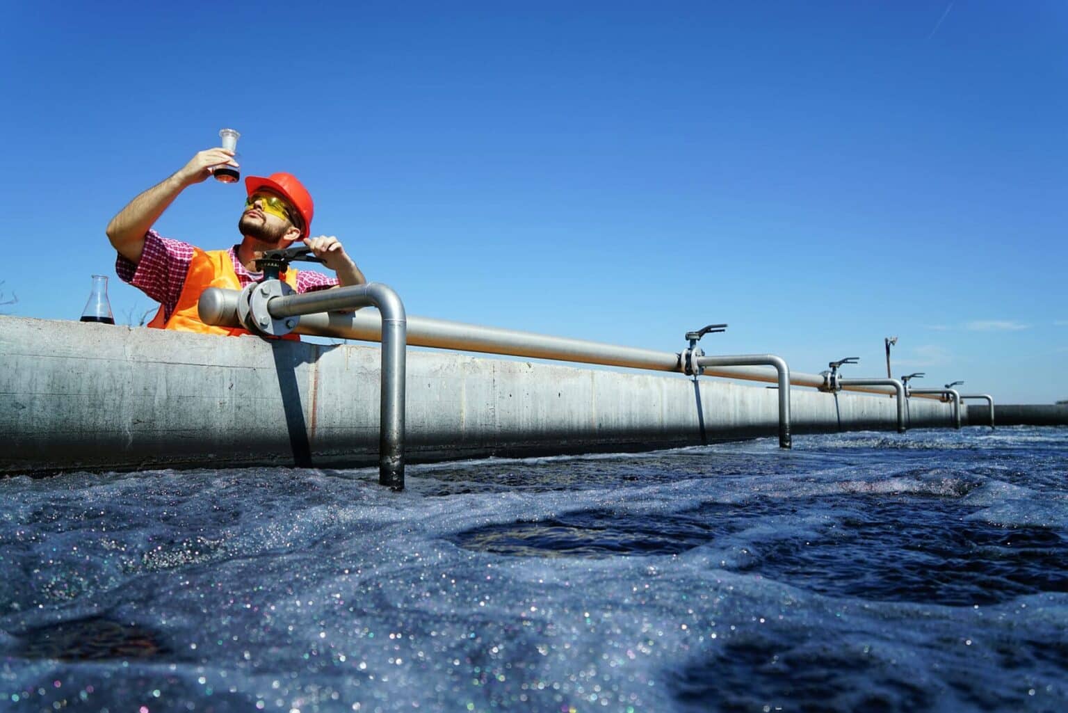 A scientist measuring sodium hypochlorite in a large water reserve